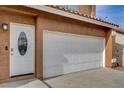 Front exterior showcasing door and garage at 8636 Caribbean Ct, Las Vegas, NV 89117