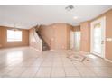 Open living space with tile floors, staircase, and a decorative glass front door at 91 Bowler Springs St, Las Vegas, NV 89148