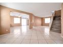 Spacious open-concept room with stairs and tile flooring throughout the space at 91 Bowler Springs St, Las Vegas, NV 89148