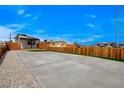 Expansive backyard featuring a concrete driveway and a patch of green artificial grass at 974 Balzar Ave, Las Vegas, NV 89106