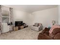 Comfortable living room featuring neutral carpet and lots of natural light at 105 Pollentia Ave, North Las Vegas, NV 89084