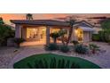 The backyard boasts a covered patio with desert landscaping, including palm trees, agave, and various succulents at 10581 Santo Marco Ct, Las Vegas, NV 89135