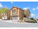 Inviting two-story home featuring a two-car garage and manicured desert landscaping, perfect for curb appeal at 10624 Tuckermans Ave, Las Vegas, NV 89129
