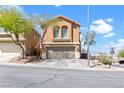 Lovely two-story home featuring a two-car garage and simple desert landscaping, a welcoming Gathering residence at 10624 Tuckermans Ave, Las Vegas, NV 89129