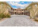 Beautiful desert landscaping frames this stylish home's courtyard and garage entries at 11870 Tevare Ln # 1085, Las Vegas, NV 89138