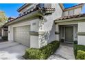 Inviting two-story home featuring a two-car garage, covered entry, and landscaped front at 1348 Calle Montery St, Las Vegas, NV 89117