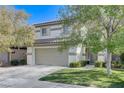 Charming two-story home with a well-maintained front yard and a spacious two car garage at 1348 Calle Montery St, Las Vegas, NV 89117