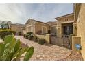 Inviting home with beautiful desert landscaping, a brick walkway and gated entry at 1779 Sebring Hills Dr, Henderson, NV 89052