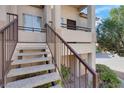 Close up of entry to a unit with a concrete staircase and iron railing at 1830 N Buffalo Dr # 2043, Las Vegas, NV 89128
