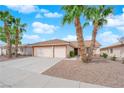 Charming single-story home featuring a three-car garage, desert landscaping, and mature palm trees at 206 Red Cloud Ter, Henderson, NV 89015
