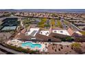 Stunning aerial view of the community center with a pool, tennis courts, and lush landscaping at 2585 Shellsburg Ave, Henderson, NV 89052
