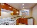 Well-lit kitchen featuring classic wood cabinets and modern white appliances at 3820 Ice Storm Ct, Las Vegas, NV 89129