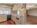 Functional kitchen with white appliances, ample cabinet space, and a view into the adjacent living room at 4000 Twain Ave, Las Vegas, NV 89121