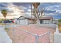 Single-story home showcasing a xeriscaped front yard and a quaint, fenced garden at 4145 Plumtree St, Las Vegas, NV 89115