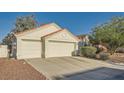 Two-car garage featuring a red tile roof and a spacious driveway at 4620 Standing Bluff Way, Las Vegas, NV 89130