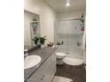 Bright bathroom with granite vanity, white cabinets, and a glass-enclosed shower at 532 Clearsable Ave, Henderson, NV 89044