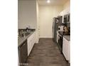 Well-equipped kitchen features stainless steel appliances, granite countertops, and white cabinets at 532 Clearsable Ave, Henderson, NV 89044