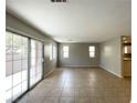 Spacious living room with large sliding doors and tile flooring at 5359 Harvest Breeze Rd, Las Vegas, NV 89118