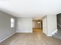 Open-concept living room with tile floors and staircase at 5359 Harvest Breeze Rd, Las Vegas, NV 89118