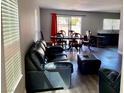 Open-concept living room with modern flooring, dining area, and lots of natural light at 6182 Blue Rapids Ct, Las Vegas, NV 89139