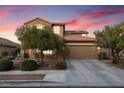 Charming two-story home featuring a well-maintained front yard, concrete driveway, and a cozy, traditional aesthetic at 648 Sunrise Lake Pl, Henderson, NV 89002