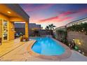 Beautiful backyard pool featuring a waterfall and tasteful landscaping, ideal for summer days and evening relaxation at 648 Sunrise Lake Pl, Henderson, NV 89002