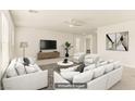 Open living room features stylish furniture, ceiling fan, and neutral decor at 6480 Chebec St, North Las Vegas, NV 89084