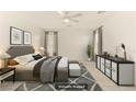 Spacious main bedroom with a ceiling fan, side table, and stylish decor at 6480 Chebec St, North Las Vegas, NV 89084