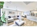 Open-concept living room with tile floors, a large sectional couch, and plenty of natural light at 759 Sunrise Crossing St, Henderson, NV 89014