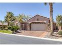 Charming single-story home featuring a tile roof, desert landscaping, and a two-car garage at 8209 Chapelle Ct, Las Vegas, NV 89131