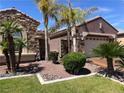 Charming single-story home with rock landscaping, mature palm trees and a two car garage at 8209 Chapelle Ct, Las Vegas, NV 89131