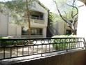 Exterior view of a condominium building with a balcony and manicured landscaping at 8250 N Grand Canyon Dr # 1121, Las Vegas, NV 89166