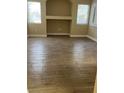 A large living room area featuring tile floors, built-in shelves and plenty of natural light at 8250 N Grand Canyon Dr # 1121, Las Vegas, NV 89166