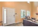 Welcoming entryway showcasing a modern door, neutral wall color, and cozy seating area at 8454 Mondavi Hill Ct, Las Vegas, NV 89139
