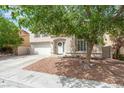 Charming home with a well-maintained front yard, mature tree, and a spacious two-car garage at 9416 Rolling Ridge Ln, Las Vegas, NV 89134