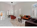 Bright living room featuring soaring ceilings, elegant tile flooring, and plenty of natural light at 9416 Rolling Ridge Ln, Las Vegas, NV 89134