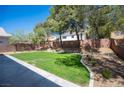 Expansive backyard with lush lawn, mature trees, and concrete patio space, perfect for outdoor living at 9750 W Cherokee Ave, Las Vegas, NV 89147