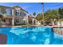 Beautiful backyard swimming pool with lush landscaping and a spacious patio area at 134 Wentworth Dr, Henderson, NV 89074