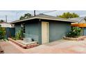 Backyard with a shed, a custom brick pathway, and desert landscaping at 1801 Griffith Ave, Las Vegas, NV 89104