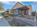 Modern home featuring a covered porch, minimalist landscaping, and a stylish red front door at 2494 Veronella St, Henderson, NV 89044