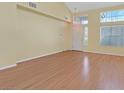 A spacious living room featuring wood floors and a front door entrance at 681 Peach Coral St, Las Vegas, NV 89183