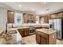Modern kitchen featuring stainless steel appliances, granite countertops, and custom cabinetry at 7806 Sundial Peak St, Las Vegas, NV 89166
