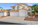 Inviting two-story home with attached two-car garage and a charming desert landscape at 9021 Canyon Magic Ave, Las Vegas, NV 89129