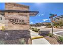 Crested Canyon community entrance with stone signage and landscaping near Lake Mead and Highland Crest street signs at 11640 Desert Hollow Ave, Las Vegas, NV 89138