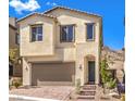 Charming two-story home with a symmetrical facade, arched entry, and attached two-car garage at 11640 Desert Hollow Ave, Las Vegas, NV 89138