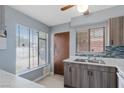 Bright kitchen with stainless steel sink, wood cabinets, white countertops and window views at 1643 E St, Las Vegas, NV 89106