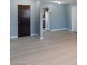 Open concept living room leads into kitchen featuring modern flooring, paint and fixtures at 1643 E St, Las Vegas, NV 89106