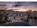 An aerial view of the home shows the architectural design and professionally landscaped grounds at 1800 Melfi Ct, Henderson, NV 89012