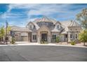 Beautiful home featuring a stone facade, porte cochere, and meticulously maintained landscaping at 1800 Melfi Ct, Henderson, NV 89012