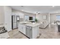 Open-concept kitchen with granite island, stainless steel appliances, and seamless flow into the living area at 4333 Glossier Ave, North Las Vegas, NV 89084